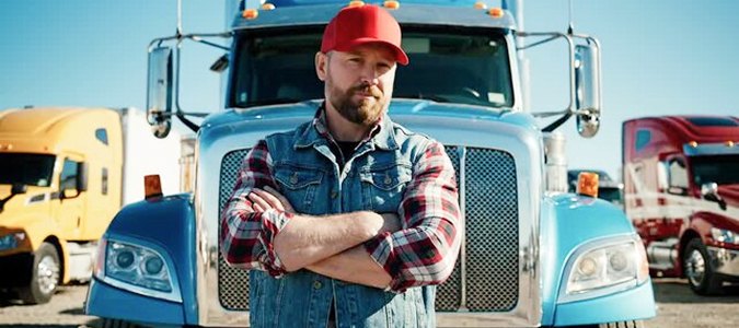 Owner-operator standing in front of his tractor