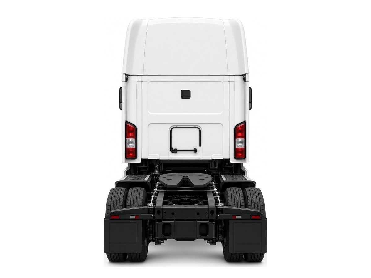 Rear of a bobtail sleeper tractor showing the fifth wheel, drive tires and mud flaps